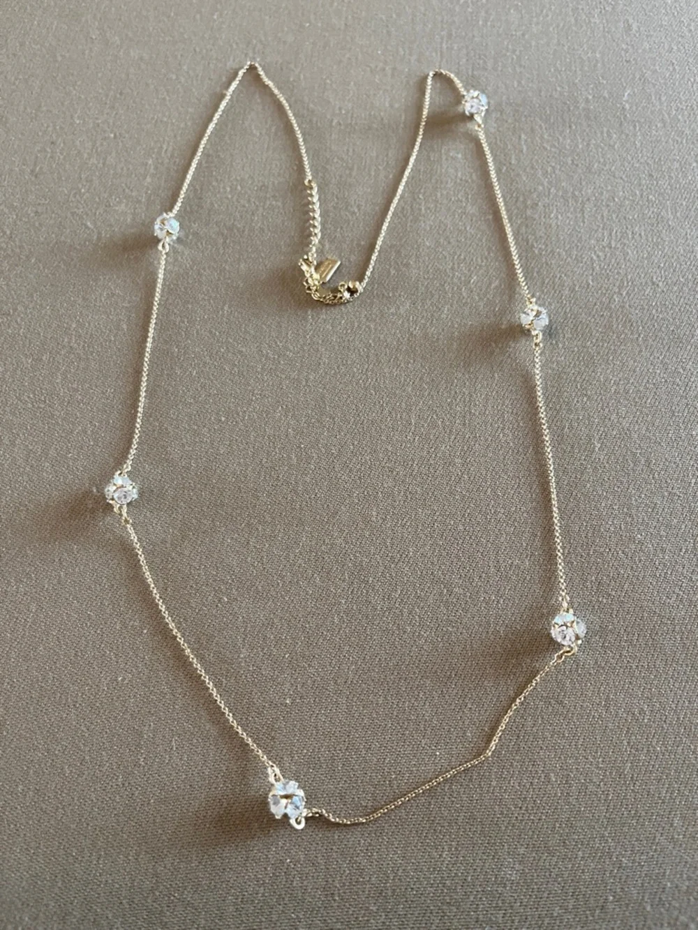 Kate Spade long golden necklace with crystal beads.